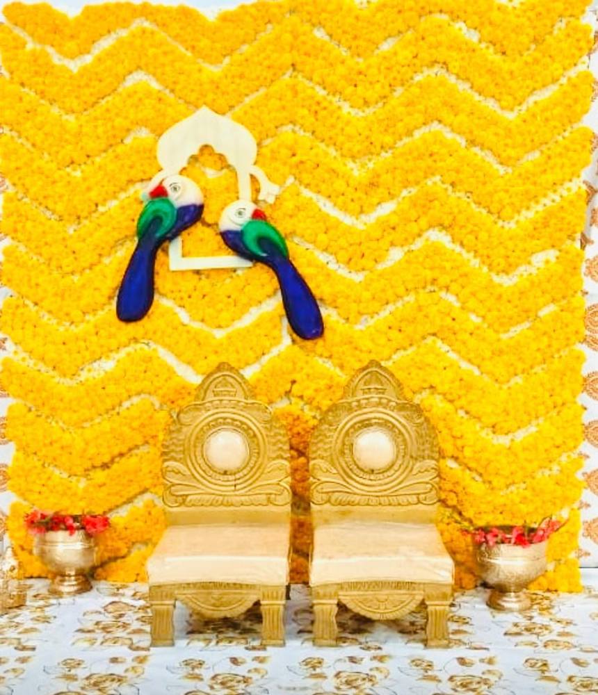 Chevron marigold backdrop with carved gold chairs