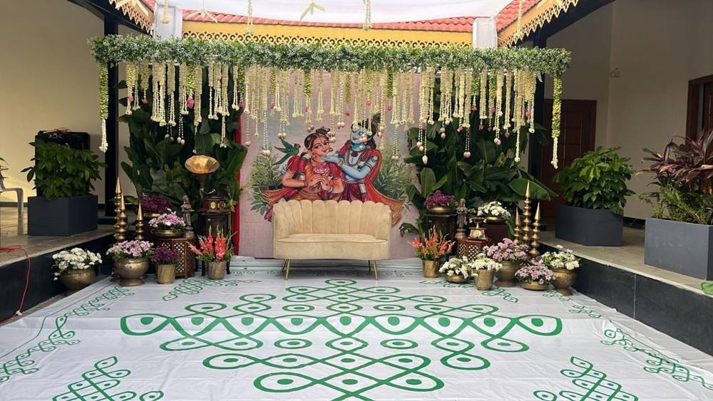 Courtyard setup with jasmine strings and green kolam floor