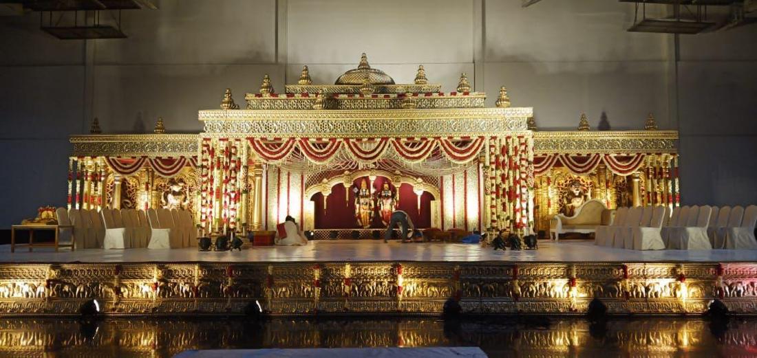 Gold traditional wedding mandap with floral garlands