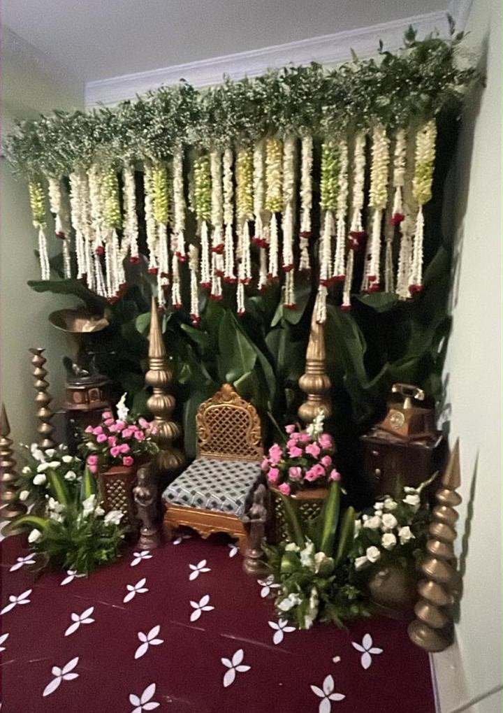 Pellikoduku ceremony setup with jasmine garlands and brass lamps